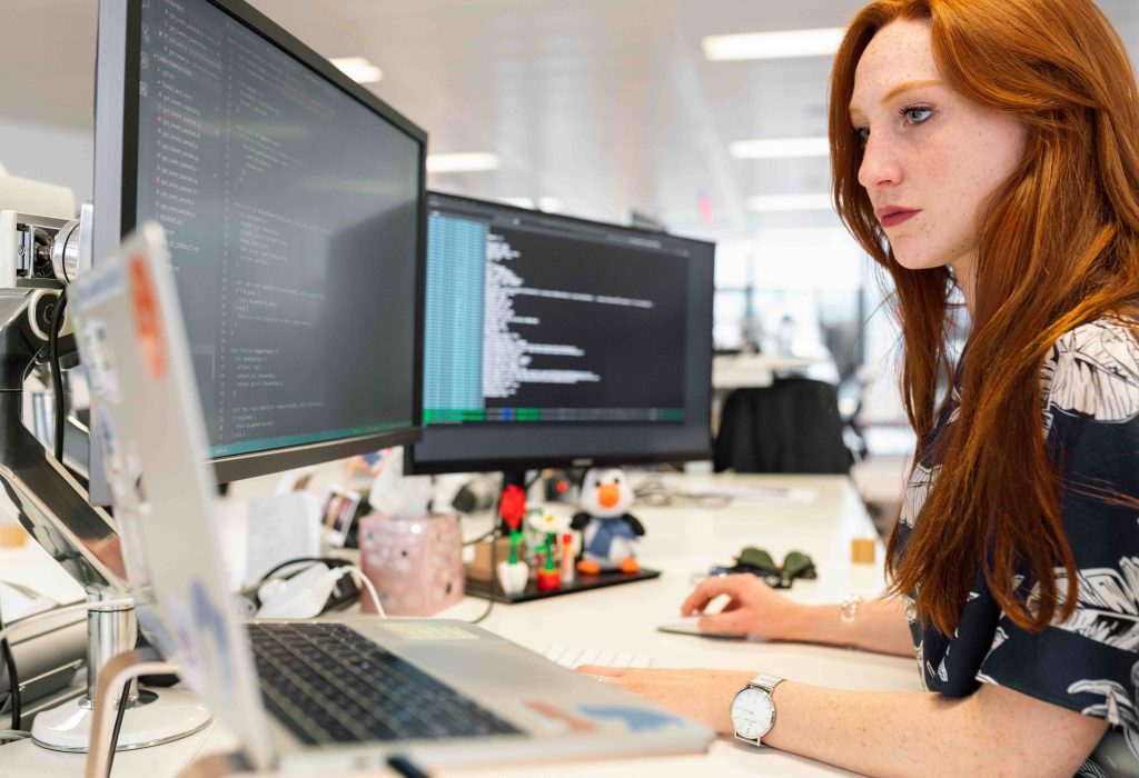 Engineer working at a workstation with multiple monitors