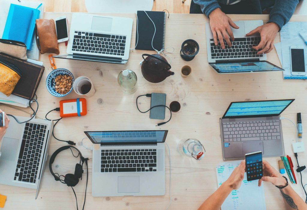 stock image of hands working at laptops
