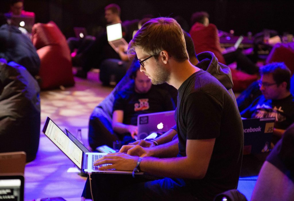 stock image of young man working on a computer at a conference